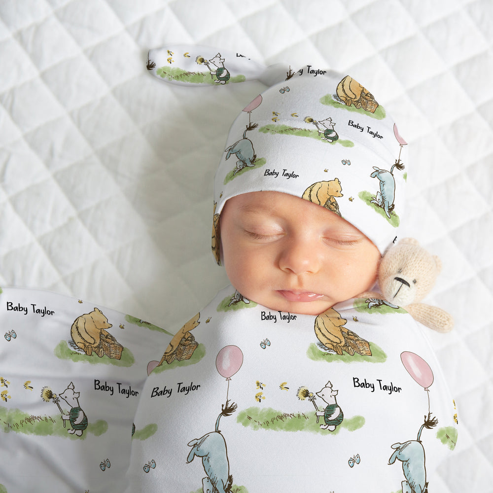 NEWBORN BABY WEARING PERSONALISED SWADDLE