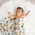 Newborn baby wrapped in personalised swaddle blanket and matching custom beanie for newborn photo shoot