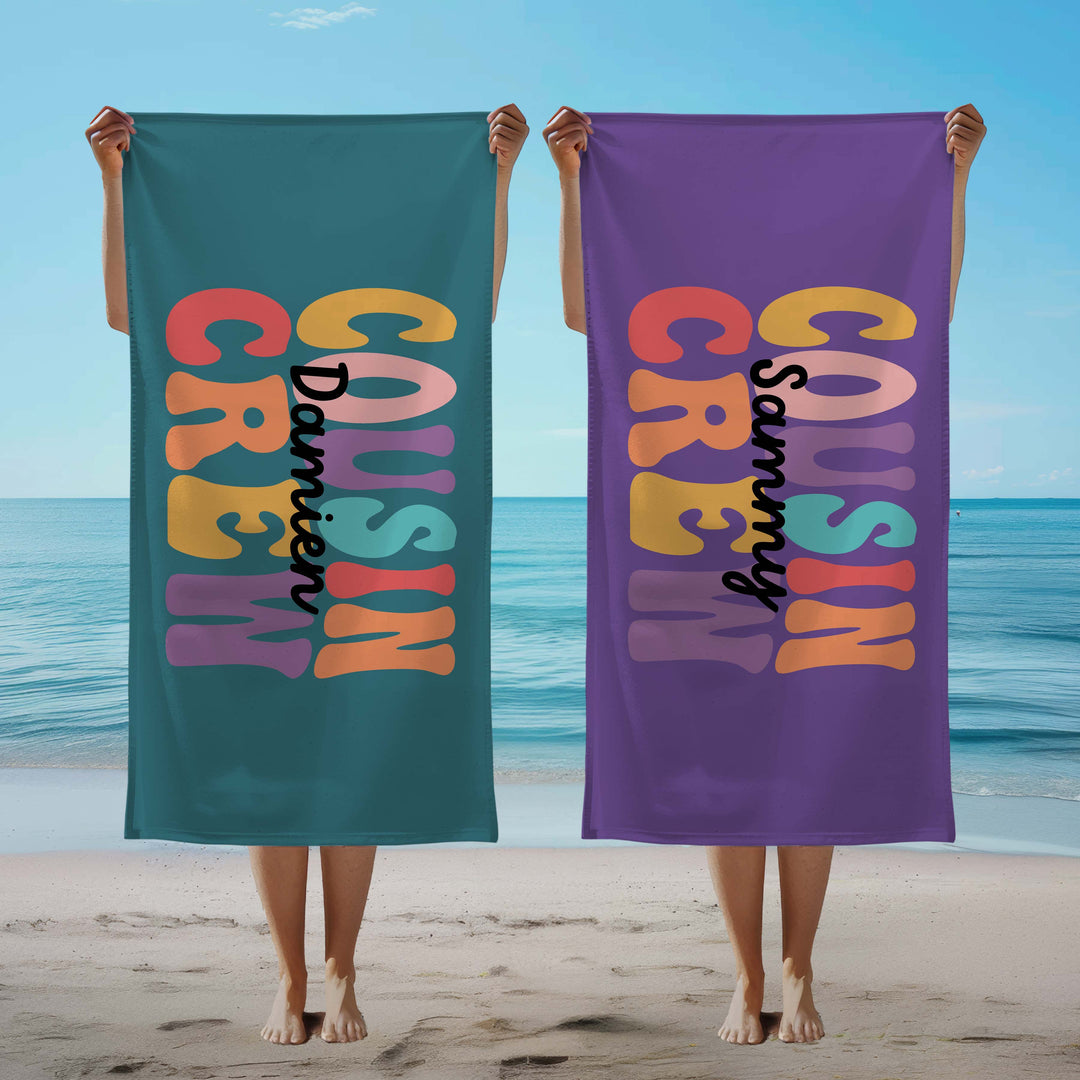 Personalised 'Cousin Crew' towels on a beach.