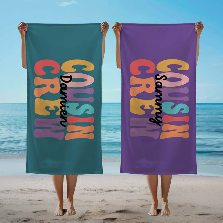 Personalised 'Cousin Crew' towels on a beach.