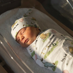 Personalised baby swaddle and beanie set in stretch poly fabric for newborn comfort and style