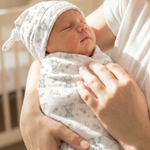 Custom swaddle wrap and beanie set made from soft premium stretch poly fabric with personalized design for newborns.