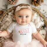 Baby wearing a Pink Bear First Christmas Onesie featuring a cute festive bear illustration and 'First Christmas' text. Perfect for newborn holiday outfits, milestone photos, and keepsake baby gifts.
