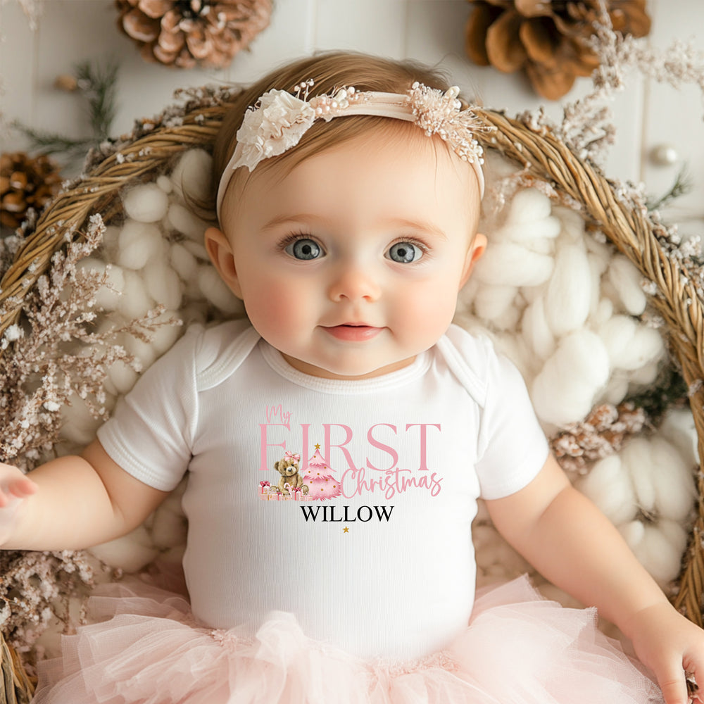 Baby wearing a Pink Bear First Christmas Onesie featuring a cute festive bear illustration and 'First Christmas' text. Perfect for newborn holiday outfits, milestone photos, and keepsake baby gifts.