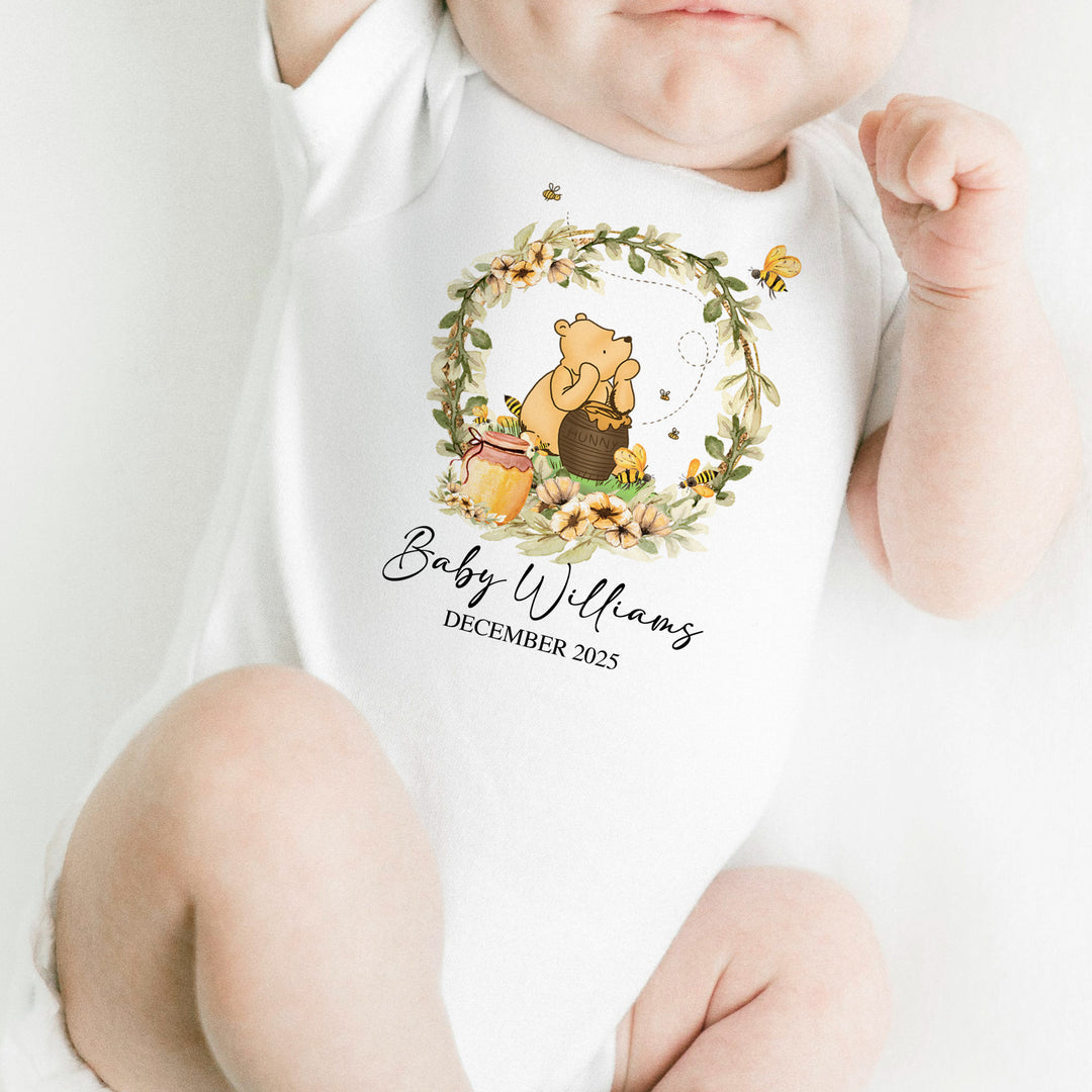 Newborn wearing Hunny Baby Onesie with Winnie the Pooh design – soft cotton baby outfit for newborn photos or baby shower gifts