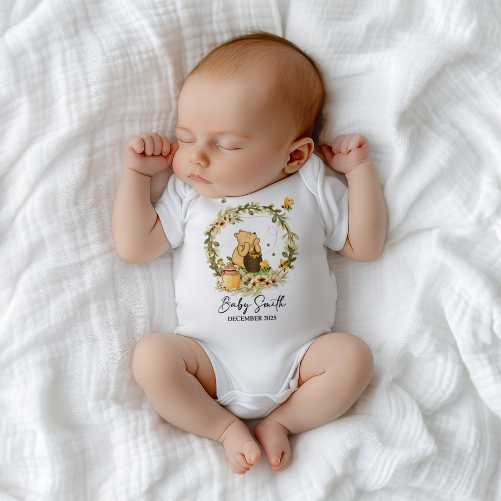 Close-up of adorable Winnie the Pooh Hunny Baby print on soft cotton onesie – perfect baby keepsake outfit