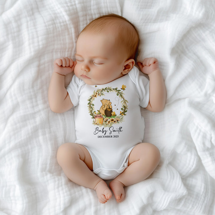Close-up of adorable Winnie the Pooh Hunny Baby print on soft cotton onesie – perfect baby keepsake outfit
