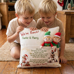 Customised "We’re Back" Christmas pillow with front elf pocket and child's name on rustic linen-style cushion cover