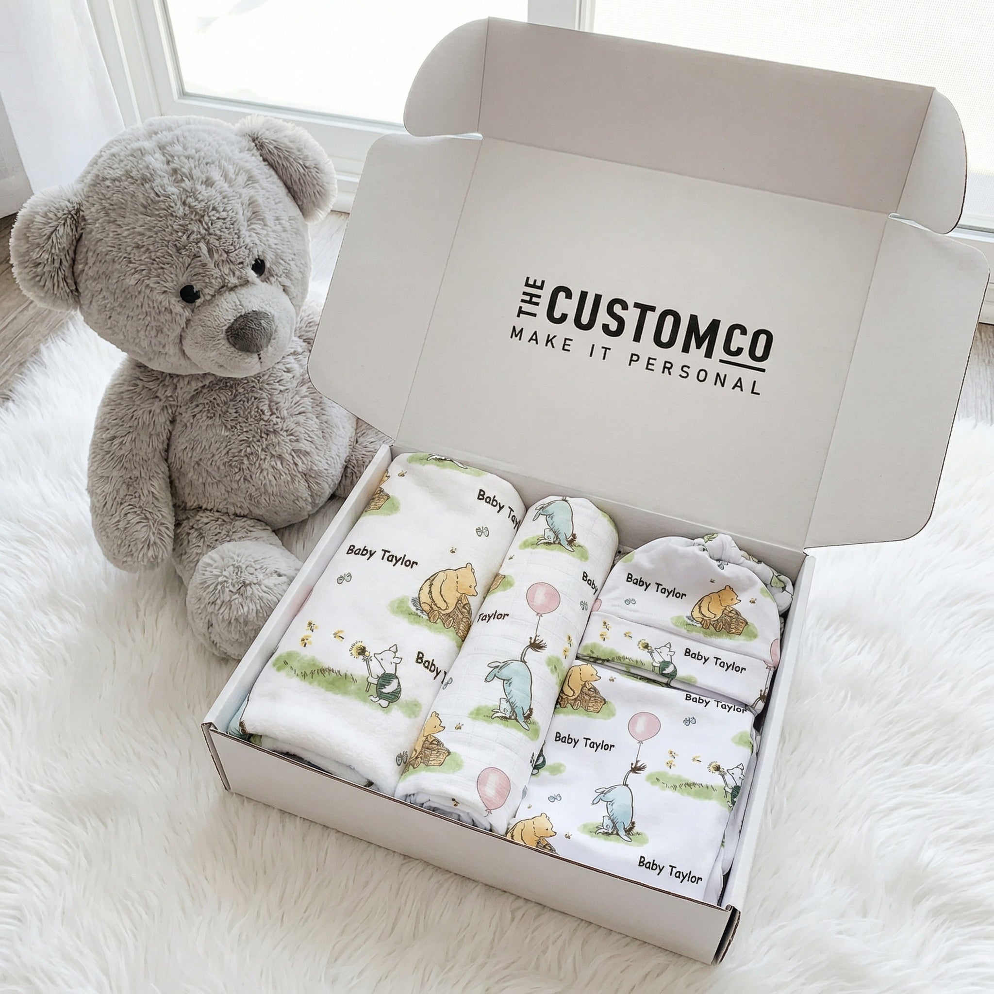 Personalised newborn essentials gift bundle with minky blanket, jersey swaddle, matching beanie, muslin swaddle, and 6-in-1 nursing cover baby box