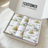 Personalised newborn essentials gift bundle with minky blanket, jersey swaddle, beanie, muslin swaddle, and 6-in-1 nursing cover baby box